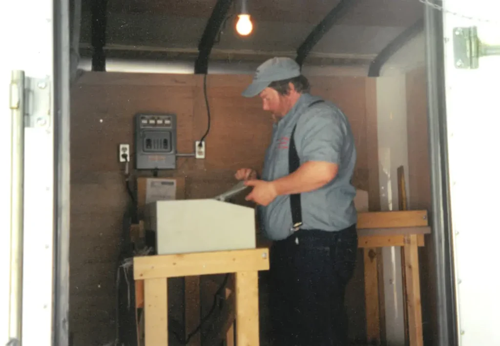 Historical photo of Country Mile Document Destruction owner shredding paper inside his traveling shredder truck - 1